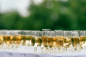 Cropped shot of shining glasses with champagne on the table