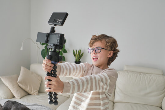 Young boy making video in his house for his channel.