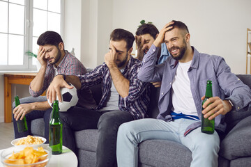 What a shame, losers. Sad disappointed sports fans watching awful terrible letdown soccer match on TV. Unhappy shocked young men face palming sitting on sofa at home frustrated with lost football game © Studio Romantic