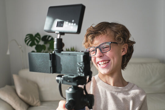 Cheerful boy making video in his house for his channel