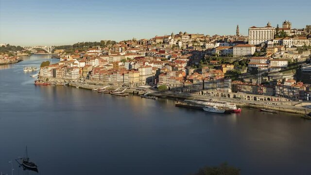 Aerial shot of old town Porto, Portugal, Europe. View on ancient city houses at the bank of Douro river. Overhead view of The Ribeira Square - historical centre of the city. 4k footage in time lapse
