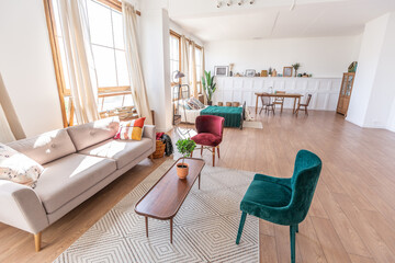 Vintage studio apartment interior in light colors in old style. huge room with large windows with a...