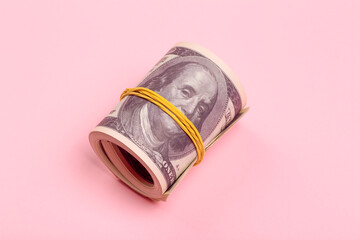 Bundle of one hundred dollar money on a pink minimal background. Cash bribe, earnings and profit...