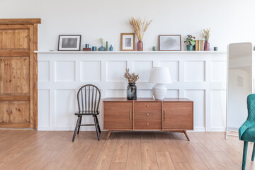 Vintage studio apartment interior in light colors in old style. huge room with large windows with a living room area and a bedroom area. direct sunlight inside.