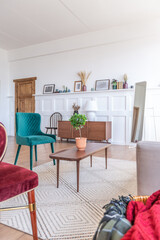 Vintage studio apartment interior in light colors in old style. huge room with large windows with a living room area and a bedroom area. direct sunlight inside.