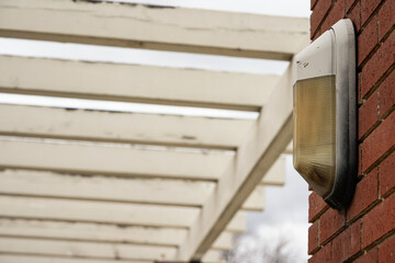 A light bulb mounted on a brick column.