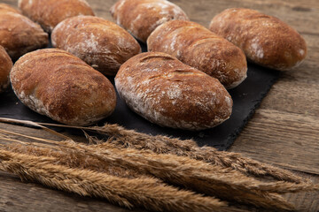 freshly baked  handmade ciabatta breads on black slate, 