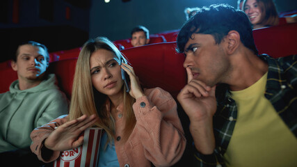 Portrait of attractive young woman talking on the phone, annoying her boyfriend while having...