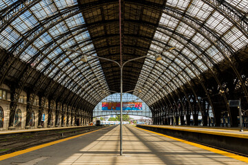 Panoramic view on a sunny day of one of the platforms of the Retiro railway terminal in Buenos Aires, built of iron and glass.