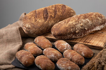 Freshly baked handmade bread with linen textile and dried bents