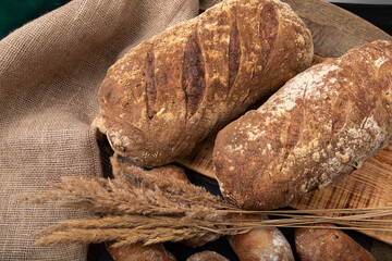 Freshly baked handmade bread with linen textile and dried bents