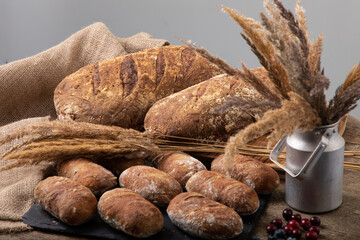 Freshly baked handmade bread with linen textile and dried bents