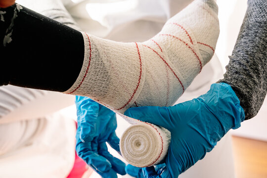 detail of a nurse's hands bandaging a foot