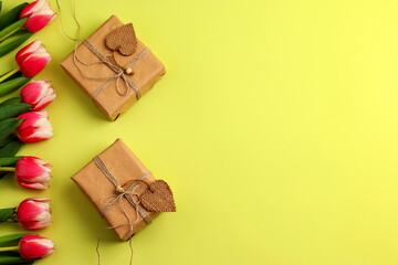 Tulips, gift boxes in craft paper, hearts from natural material on a light background. Festive concept for Valentine's Day, Mother's Day, Women's Day and Birthday. Flatlay, copy space.