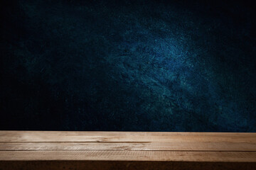 dark wall background. Empty workplace, in front of an abstract package.