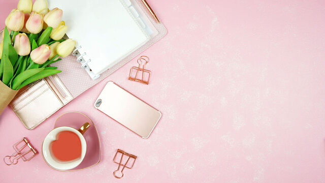 Springtime pink theme desktop workspace with mockups on stylish textured background. Top view blog hero header creative composition flat lay.
