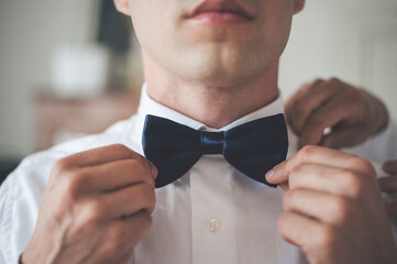 man adjusting tie