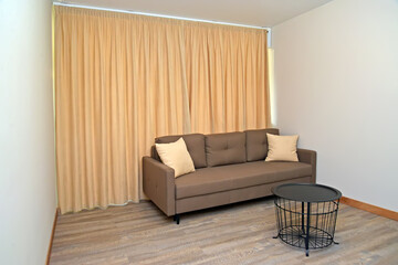A fragment of a living room with a metal coffee table. Modern minimalism