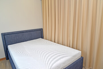Double bed and curtains in the bedroom