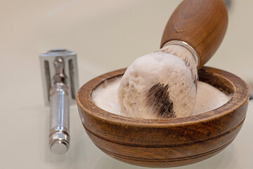wooden bowl with shaving soap, vegan razor brush and razor
