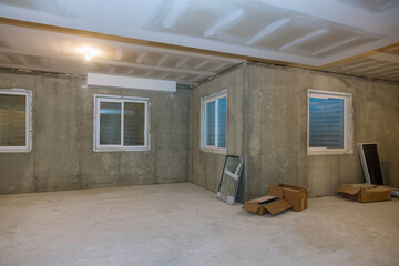 Unfinished view on concrete floor construction of basement empty under construction of home