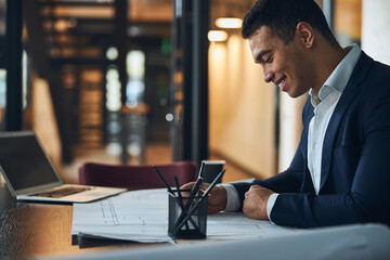 Joyous architect working on a new building plan