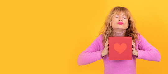 woman kissing with gift box with heart, valentine days