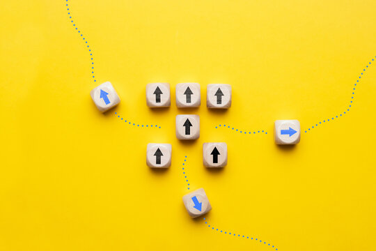 The concept of an alternative or change of path in the form of wooden cubes with arrows