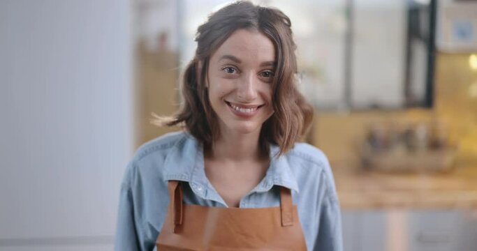 Portrait of a happy housewife boiling some food on the kitchen at home. Household chores and home routine concept Dolly out shot