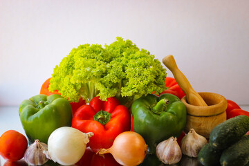 Prepare for a wonderful vegetarian lunch. Washed bell peppers, onions, garlic and lettuce leaves