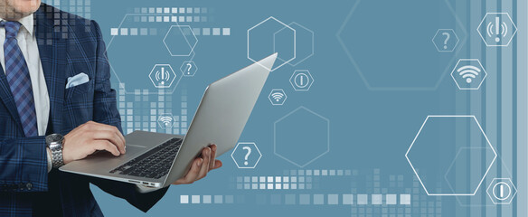 A man in a business suit and tie holds an open laptop in his hand. Blue background with geometric shapes.