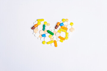 Assorted pharmaceutical medicine pills, tablets, and capsules for the treatment of heart disease isolated on white background