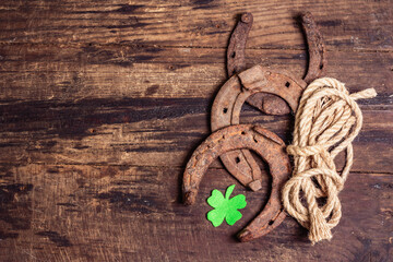 Badly worn horseshoes, rope, and felt clover leaf