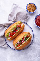 Hot dogs with sausage, sauces and vegetables