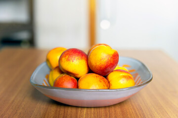 Ripe bright apricots on a table in a plate