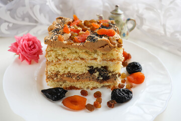 sweet dessert. sponge cake with prunes, dried apricots, raisins and poppy seeds 