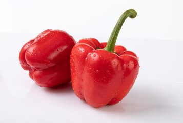 Red bell pepper with water droplets on white background