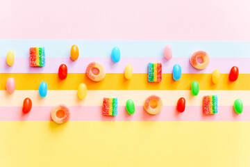 Rainbow juicy gummy candies background. Pattern from jelly sweets on colorful background. Top view