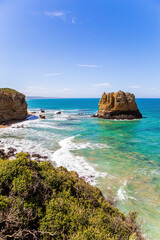 Coastal rocks in the ocean surf