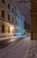 Winter in Krakow, Poselska street covered in snow, night, Poland