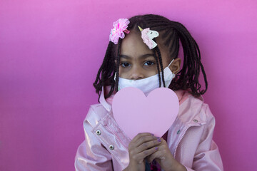 Portrait of a little multiracial girl wearing a medical mask