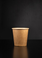 disposable cup for coffee on a black background. natural eco packaging