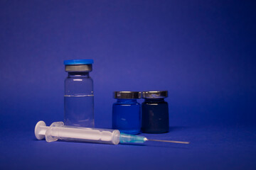 three transparent Vaccine bottle phial with no label, medical syringe injection needle. isolated on...