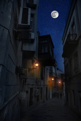 Full moon over the city at night, Baku Azerbaijan. Big full moon shining bright over buildings