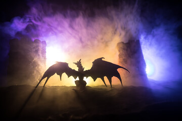 Battle between dragon and heroic soldiers. Creative table decoration. Selective focus