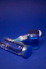 two transparent Vaccine bottle phial with no label, medical syringe injection needle. isolated on...