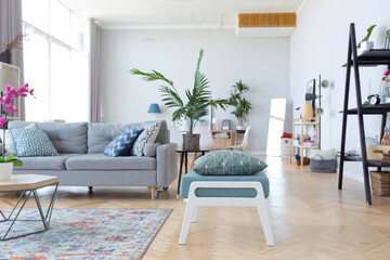 The interior design of the studio apartment in Scandinavian style. A spacious huge room in light...