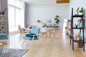 The interior design of the studio apartment in Scandinavian style. A spacious huge room in light colors. stylish expensive luxury furniture.