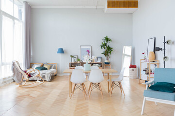 The interior design of the studio apartment in Scandinavian style. A spacious huge room in light colors. stylish expensive luxury furniture.