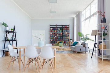 The interior design of the studio apartment in Scandinavian style. A spacious huge room in light colors. stylish expensive luxury furniture.